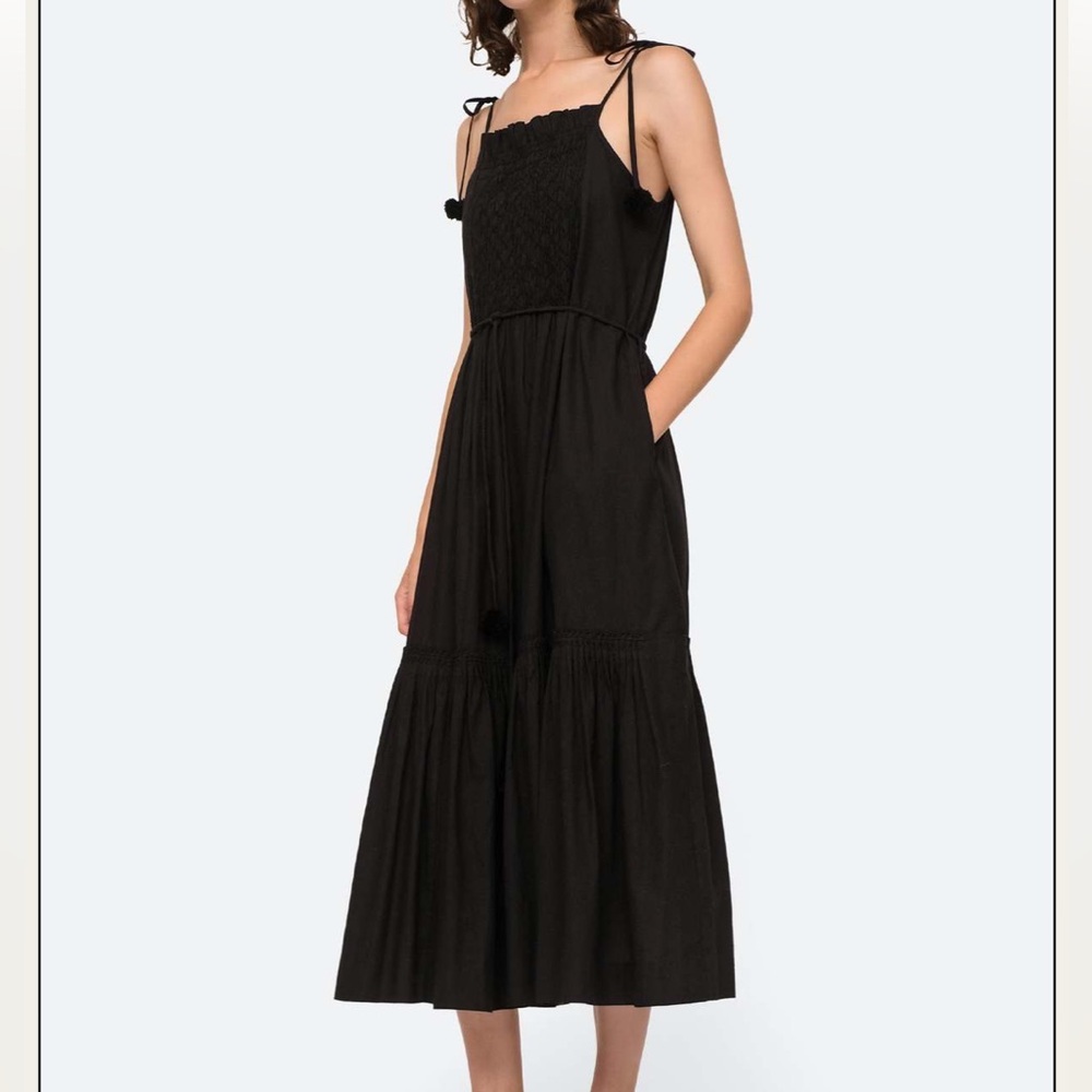 SEA NY Willa smocked dress in black. Perfect for a beach vacation.Pom Pom detail